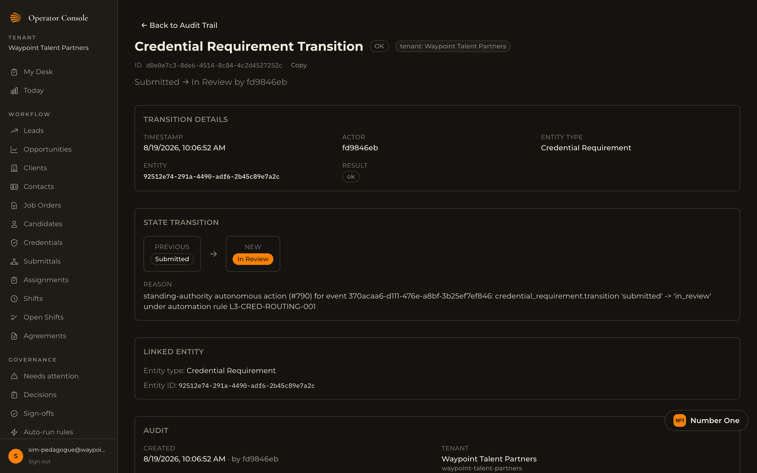 Audit trail detail for a credential requirement transition from Submitted to In Review, showing timestamp, actor, entity, and a change reason naming the automation rule that authorized it.