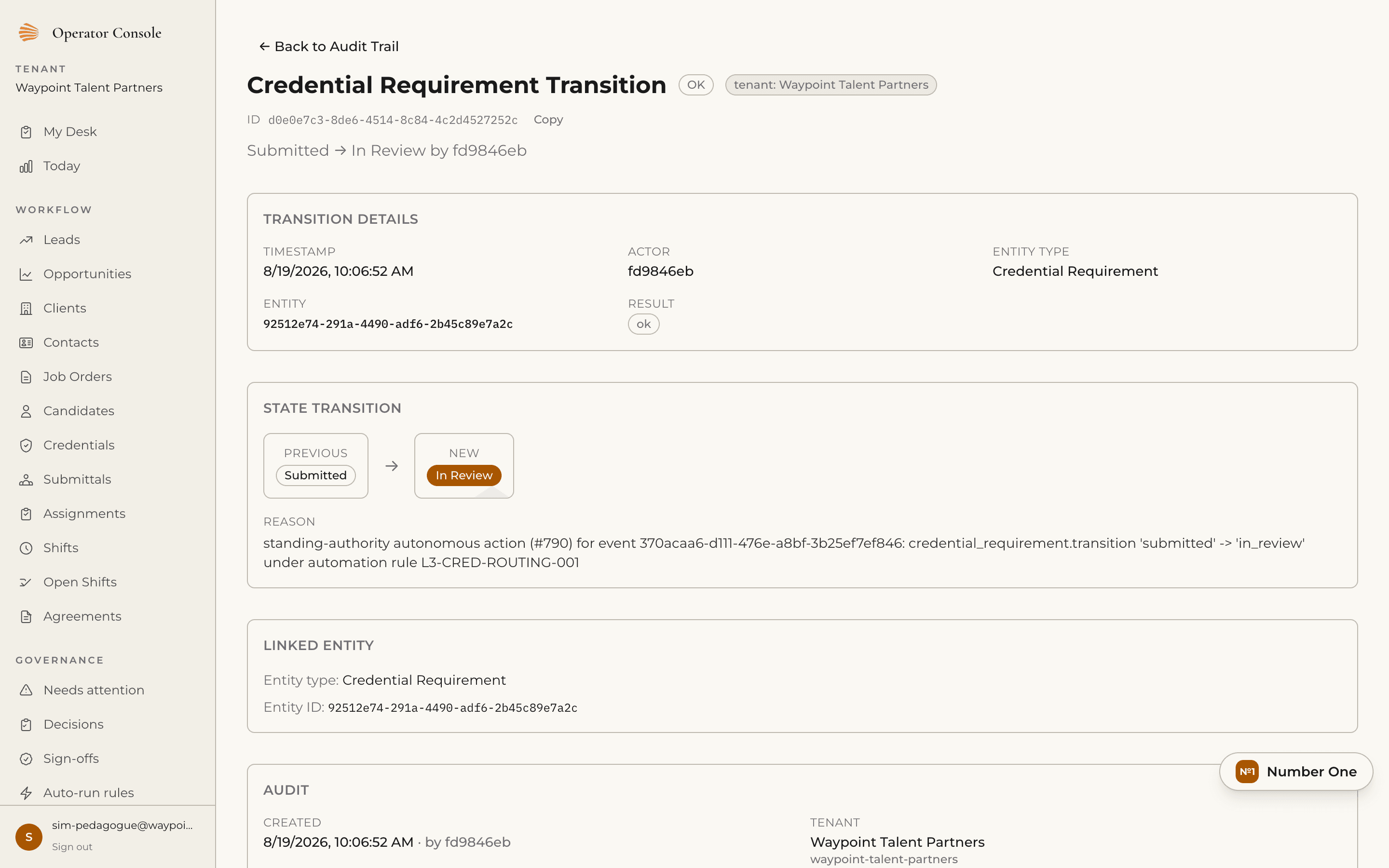 Audit trail detail for a credential requirement transition from Submitted to In Review, showing timestamp, actor, entity, and a change reason naming the automation rule that authorized it.
